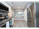 Bright kitchen featuring a stainless refrigerator, bay window, and modern appliances at 7736 Falcon Rest Cir, Raleigh, NC 27615