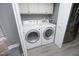 Laundry room with washer, dryer and white cabinets for storage at 7736 Falcon Rest Cir, Raleigh, NC 27615