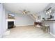 Open concept living area with a fireplace, ceiling fan and bar seating at 7736 Falcon Rest Cir, Raleigh, NC 27615