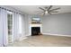 Comfortable living room featuring a fireplace, light gray walls, and a glass patio door at 7736 Falcon Rest Cir, Raleigh, NC 27615