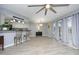 Spacious living area boasting bar seating, patio access, and modern ceiling fan at 7736 Falcon Rest Cir, Raleigh, NC 27615