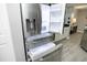 Stainless steel refrigerator shown with open door and drawers in bright kitchen at 7736 Falcon Rest Cir, Raleigh, NC 27615