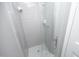 Clean shower stall featuring tiled walls, a clear glass door, and chrome fixtures for a modern aesthetic at 7736 Falcon Rest Cir, Raleigh, NC 27615