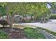 Landscaped street view of the community with mature trees and manicured lawns at 7736 Falcon Rest Cir, Raleigh, NC 27615