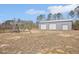 Spacious backyard featuring a metal building and a swing set at 7880 Flower Hill Rd, Middlesex, NC 27557