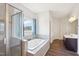 Elegant bathroom showcasing a soaking tub with jets, walk-in shower, and outside view at 7880 Flower Hill Rd, Middlesex, NC 27557