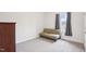 Simple bedroom featuring a futon, neutral carpet, and a window at 7880 Flower Hill Rd, Middlesex, NC 27557