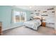 Cozy bedroom with a decorative wood accent wall and a comfortable bed at 7880 Flower Hill Rd, Middlesex, NC 27557