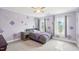 Bedroom with lilac colored walls, patterned decals, two windows, and gray furnishings at 7880 Flower Hill Rd, Middlesex, NC 27557