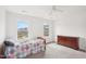 Well-lit bedroom with two windows, dresser, bed, and neutral carpet at 7880 Flower Hill Rd, Middlesex, NC 27557