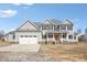 Traditional two-story home featuring an attached two-car garage, covered porch, and neutral siding at 7880 Flower Hill Rd, Middlesex, NC 27557
