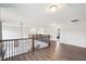 Second story hallway with wooden railings overlooking the first floor at 7880 Flower Hill Rd, Middlesex, NC 27557
