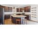 A kitchen featuring dark brown cabinets, granite countertops, a kitchen island with seating, and stainless steel appliances at 7880 Flower Hill Rd, Middlesex, NC 27557