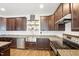 A spacious kitchen featuring granite countertops, stainless steel appliances and dark cabinets at 7880 Flower Hill Rd, Middlesex, NC 27557