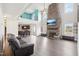 Open living room featuring a floor-to-ceiling stone fireplace, high ceilings, and plenty of natural light at 7880 Flower Hill Rd, Middlesex, NC 27557