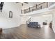 Spacious living room with dark wood floors, modern furnishings and staircase to the second floor at 7880 Flower Hill Rd, Middlesex, NC 27557