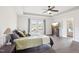 A spacious bedroom suite with wood floors, tray ceiling, fan, and a door to the outside deck at 7880 Flower Hill Rd, Middlesex, NC 27557