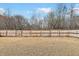 Spacious backyard with a wooden fence and gate at 8008 Hergety Dr, Raleigh, NC 27603