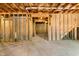 Spacious unfinished basement with exposed ceiling insulation and wooden support beams at 8008 Hergety Dr, Raleigh, NC 27603