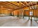 Unfinished basement with exposed ceiling beams, wood framing, and a concrete floor at 8008 Hergety Dr, Raleigh, NC 27603