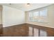 A bright bedroom features a dark wood floor and large window at 8008 Hergety Dr, Raleigh, NC 27603