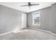 Cozy bedroom with gray walls, carpet, a window with natural light, and a ceiling fan at 8008 Hergety Dr, Raleigh, NC 27603