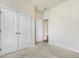 Neutral bedroom featuring carpet flooring, a large closet, and a door to an adjoining room at 8008 Hergety Dr, Raleigh, NC 27603