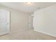 A bedroom featuring neutral walls, carpet, and a doorway leading into an adjacent room at 8008 Hergety Dr, Raleigh, NC 27603