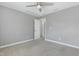 Neutrally painted bedroom with carpet, ceiling fan, and a doorway leading to another room at 8008 Hergety Dr, Raleigh, NC 27603