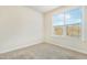 This bedroom features neutral carpet and one window at 8008 Hergety Dr, Raleigh, NC 27603