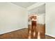 This open dining room has dark wood floors and is adjacent to the kitchen at 8008 Hergety Dr, Raleigh, NC 27603