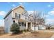 A charming home showcasing a cozy porch, manicured lawn and two-car garage at 8008 Hergety Dr, Raleigh, NC 27603