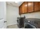 Well-equipped laundry room with washer, dryer, and storage cabinets at 8008 Hergety Dr, Raleigh, NC 27603