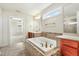 Main bathroom featuring a large soaking tub, shower, and separate vanities at 8008 Hergety Dr, Raleigh, NC 27603