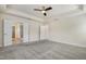 Main bedroom featuring tray ceilings, ceiling fan, and carpeted floors at 8008 Hergety Dr, Raleigh, NC 27603