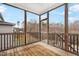 Screened porch with wood flooring, railing, and large windows providing natural light at 8008 Hergety Dr, Raleigh, NC 27603