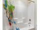 Shower-tub combination with a shower curtain featuring a colorful world map at 8008 Hergety Dr, Raleigh, NC 27603