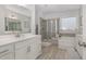 Bathroom features a shower, tub, vanity, and large mirror at 824 Wrights Creek Way, Wake Forest, NC 27587