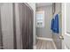 Well-lit bathroom features a neutral color palette and a shower with curtain at 824 Wrights Creek Way, Wake Forest, NC 27587