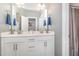 Clean bathroom with a double vanity, white cabinets, and modern fixtures at 824 Wrights Creek Way, Wake Forest, NC 27587