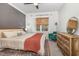 Bedroom featuring a plush bed, hardwood dresser, modern ceiling fan, and neutral color palette at 824 Wrights Creek Way, Wake Forest, NC 27587