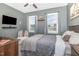 Comfortable bedroom with a cozy bed, accent chair, and ample natural light at 824 Wrights Creek Way, Wake Forest, NC 27587