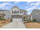 Charming two-story home with stone accents, a covered porch, and well-maintained landscaping at 824 Wrights Creek Way, Wake Forest, NC 27587