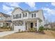 Charming two-story home with gray stone accents and a covered front porch at 824 Wrights Creek Way, Wake Forest, NC 27587