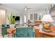 Bright living room with ceiling fan, striped rug, modern sofa, and many windows at 824 Wrights Creek Way, Wake Forest, NC 27587