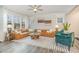 Bright living room features a large sectional sofa, modern ceiling fan, and lots of natural light at 824 Wrights Creek Way, Wake Forest, NC 27587