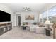 Open living room features a stylish sectional sofa, wall art, and ample natural light at 824 Wrights Creek Way, Wake Forest, NC 27587