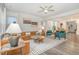 A spacious living room features a tan leather sofa, stylish rug, and neutral color palette at 824 Wrights Creek Way, Wake Forest, NC 27587