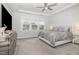 Main bedroom with plush bed, ceiling fan, lots of windows, and neutral color palette at 824 Wrights Creek Way, Wake Forest, NC 27587