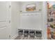 Mudroom with built-in bench, coat hooks, storage cubbies, and access to a pantry at 824 Wrights Creek Way, Wake Forest, NC 27587